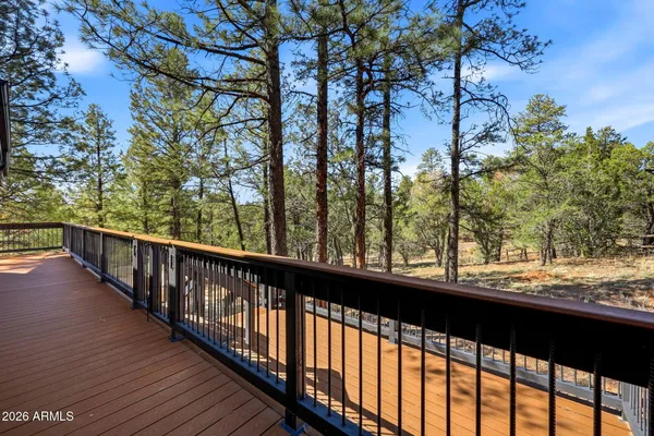 a view of balcony with wooden floor and fence