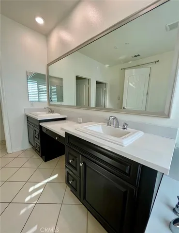 a bathroom with a sink double vanity and a mirror