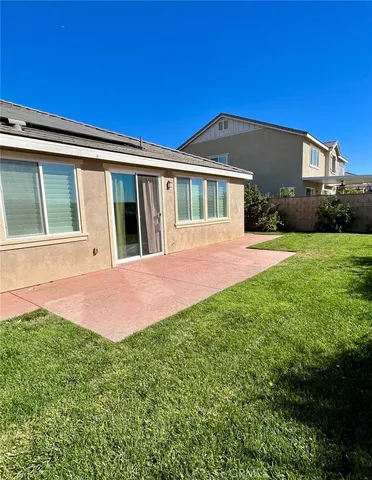 a front view of a house with yard and green space