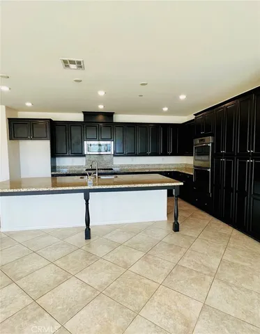a kitchen with kitchen island cabinets and a sink