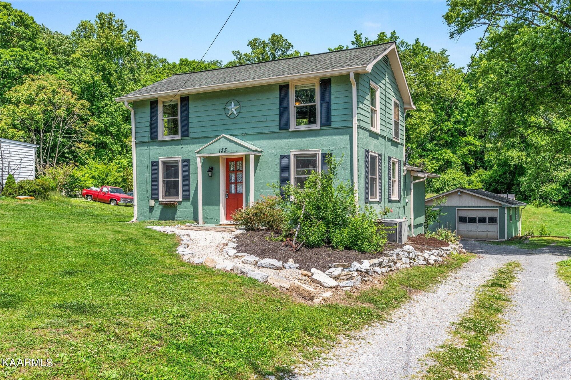 133 Oak Road Norris, TN 37828 - Photo 1 of 24 a front view of a house with garden