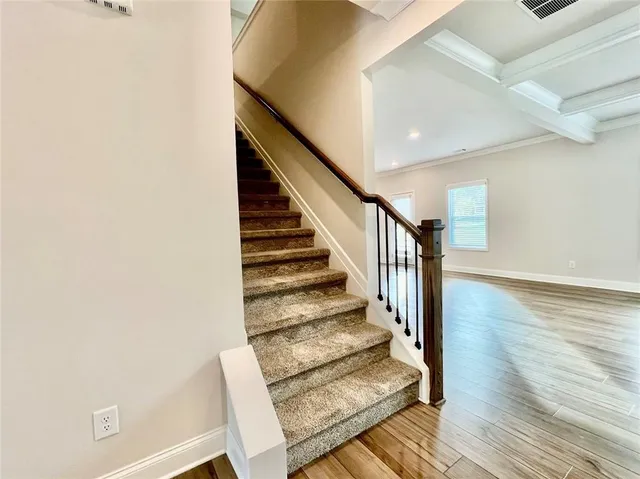 a view of entryway and hall with wooden floor
