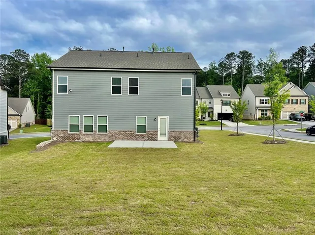 a view of a house with swimming pool and sitting area