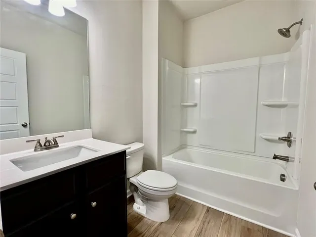 a bathroom with a sink a toilet and a bathtub