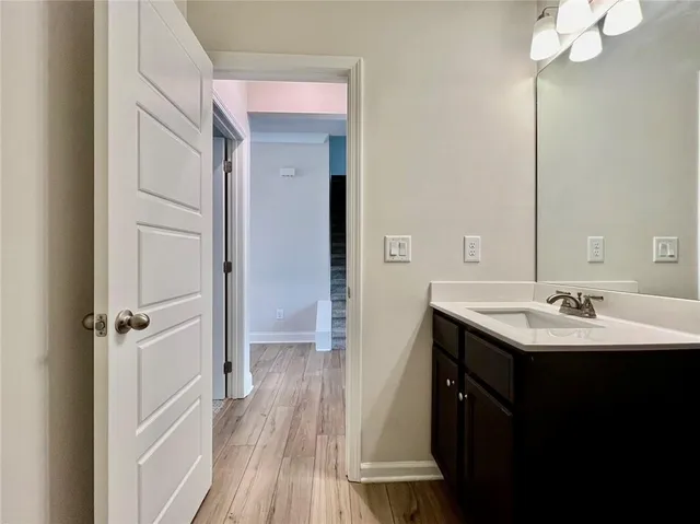 a bathroom with a sink a mirror and a shower