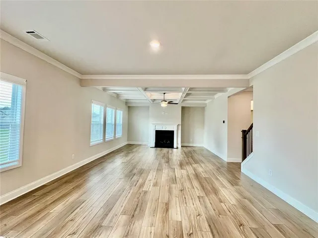 wooden floor in an empty room with a fireplace