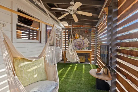 a view of a patio with table and chairs a barbeque with wooden floor and roof