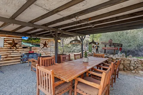 a view of a patio with table and chairs and potted plants