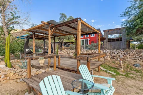 a view of a porch with furniture and a yard