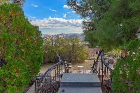 a view of a patio with a table and chairs under an umbrella