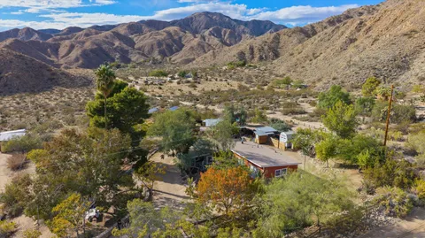 a view of a chairs and table in a backyard