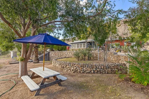 an aerial view of residential houses with outdoor space and trees