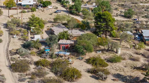a view of a chairs and table in backyard