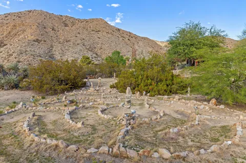 a view of mountains in middle of the green field
