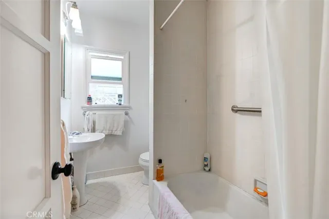 a living room with furniture a fireplace and a large window