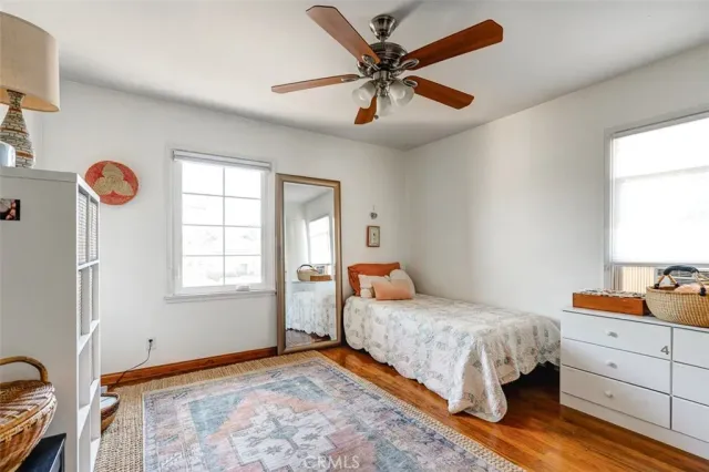 an empty room with wooden floor and closet