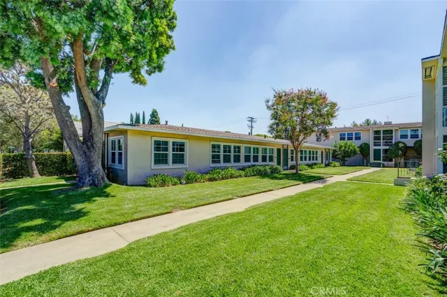 a view of a brick building next to a yard