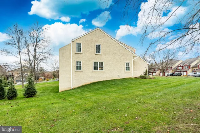 a house with a big yard and large trees