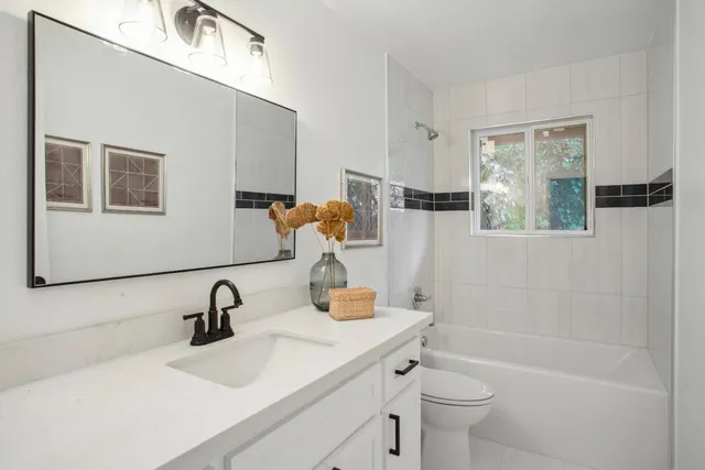 a bathroom with a sink double vanity and a toilet