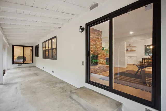 a view of a room with window and hardwood floor