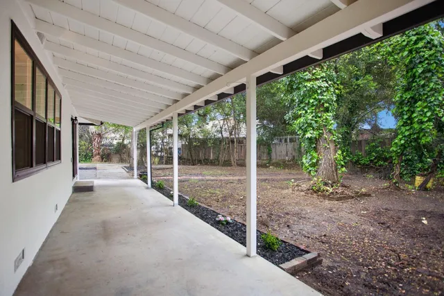 a view of a house with backyard and balcony