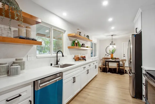 a kitchen with sink cabinets and stove
