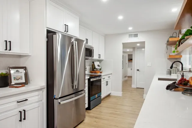 a kitchen with stainless steel appliances a refrigerator and a sink