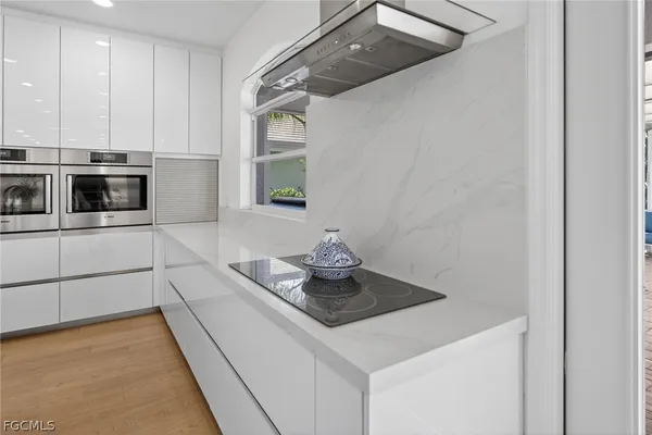 a kitchen with sink cabinets and microwave