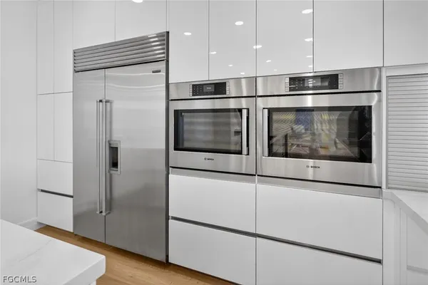 a kitchen with stainless steel appliances granite countertop a refrigerator and a microwave