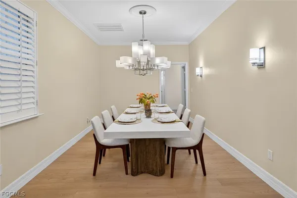 a view of a dining room with furniture and chandelier