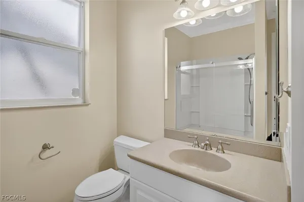 a bathroom with a sink toilet and mirror
