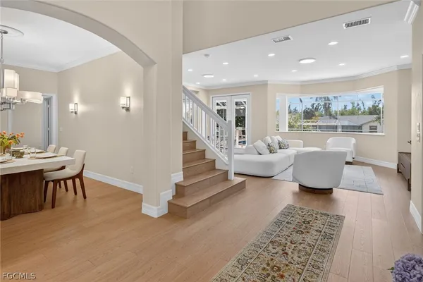 a living room with furniture a rug and a painting