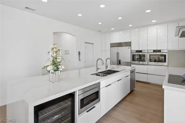 a kitchen with stainless steel appliances a sink stove and cabinets