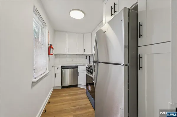 a white refrigerator freezer and a stove sitting inside of a kitchen