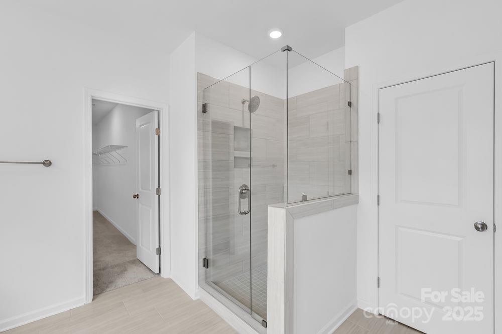 173 Glenn Drive Mooresville, NC 28115 - Photo 15 of 35 a bathroom with a shower and a glass door