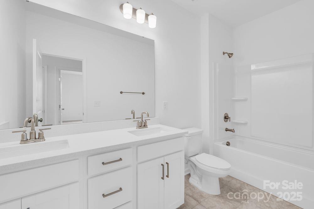 173 Glenn Drive Mooresville, NC 28115 - Photo 16 of 35 a bathroom with a sink a toilet and shower