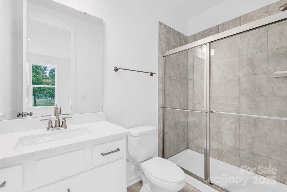 173 Glenn Drive Mooresville, NC 28115 - Photo 25 of 35 a bathroom with a sink toilet and shower
