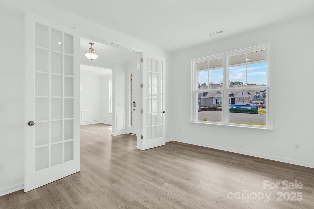 173 Glenn Drive Mooresville, NC 28115 - Photo 10 of 35 an empty room with wooden floor and a window