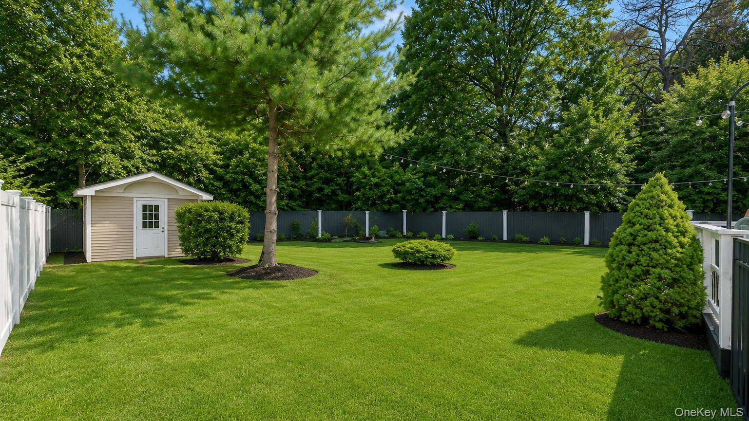 19 Joan Road Bay Shore, NY 11706 - Photo 49 of 50 Expansive green lawn featuring a storage shed with siding, white trim, and a paneled door