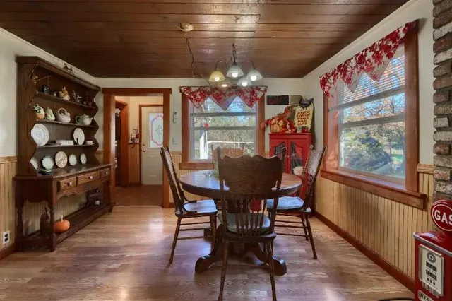 a view of a dining room with furniture a chandelier and wooden floor