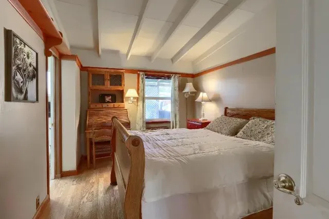 a bed room with a bed and a tv