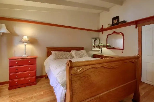 a bedroom with a bed and a dresser