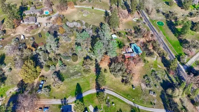 an aerial view of residential house and sandy dunes
