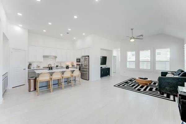 a large kitchen with a table and chairs