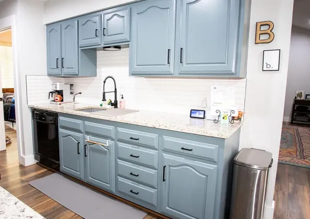 a kitchen with stainless steel appliances granite countertop a sink stove and cabinets