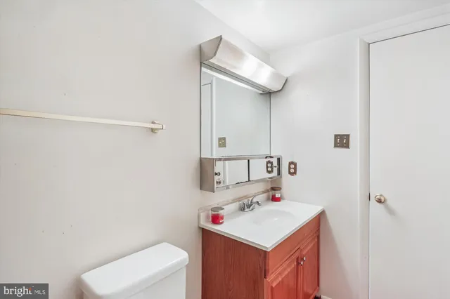a bathroom with a sink a toilet and mirror