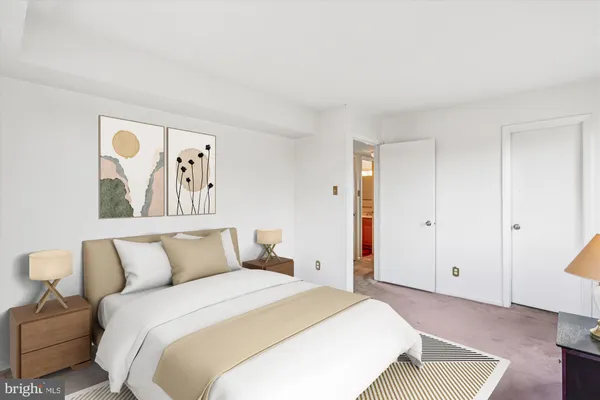 a bedroom with a bed and a painting on the wall