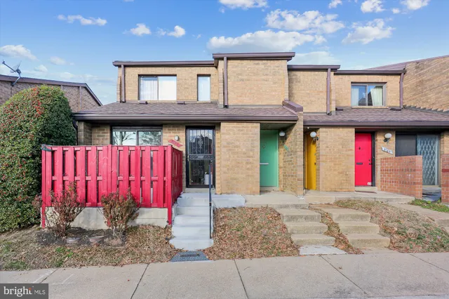 a view of a house with a bed and potted plants