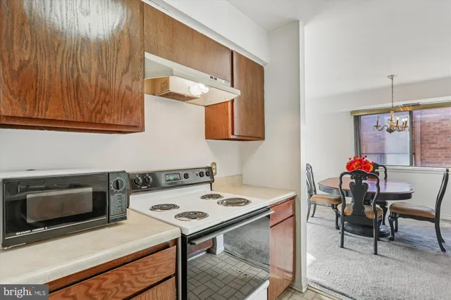 a kitchen with a stove a microwave and a table