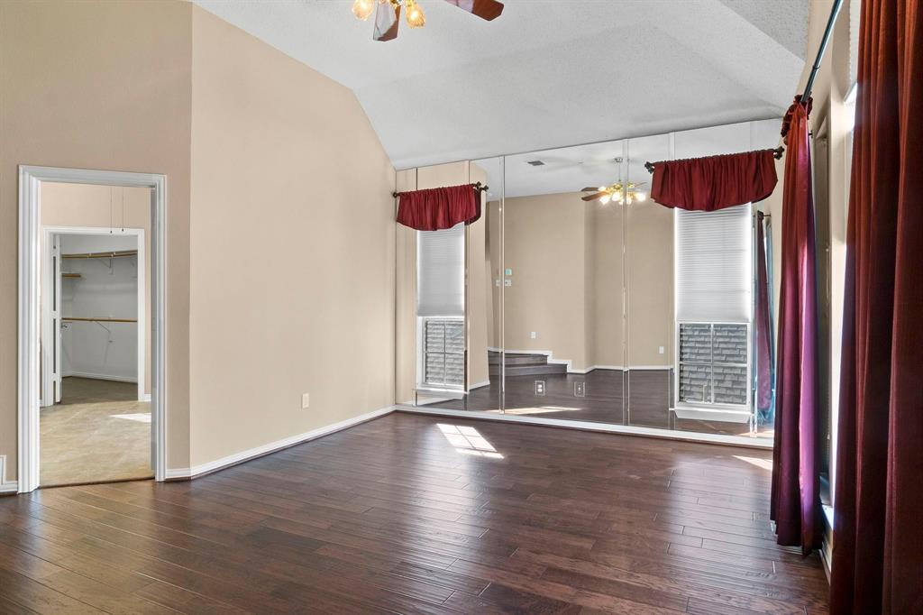 14588 Poe Court Addison, TX 75001 - Photo 22 of 28 an empty room with wooden floor and windows
